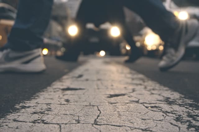 pedestrians crossing street with traffic