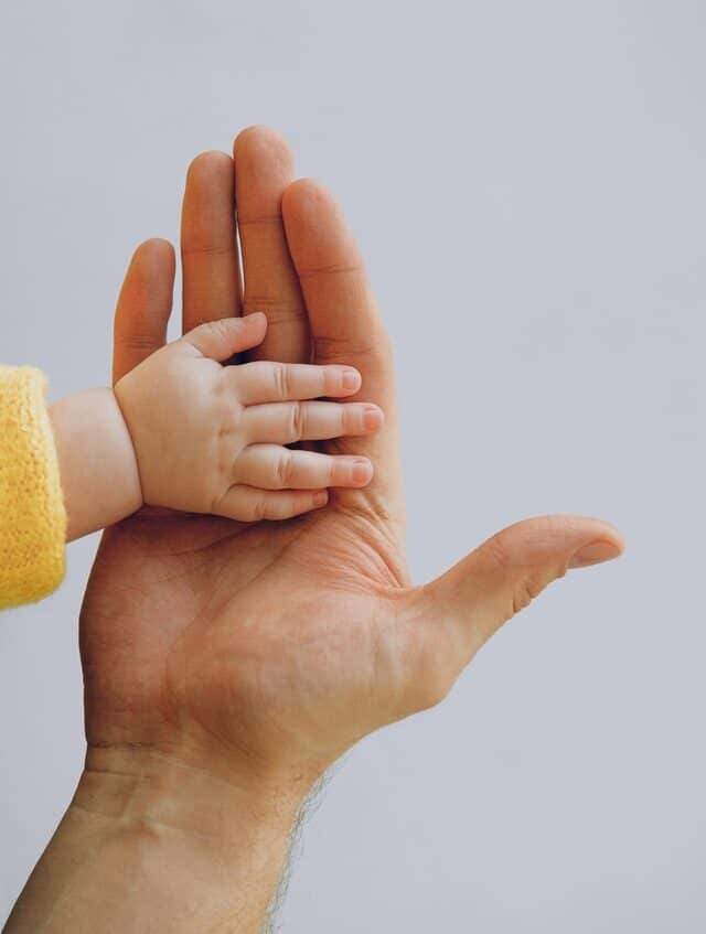 baby hand in adult hand